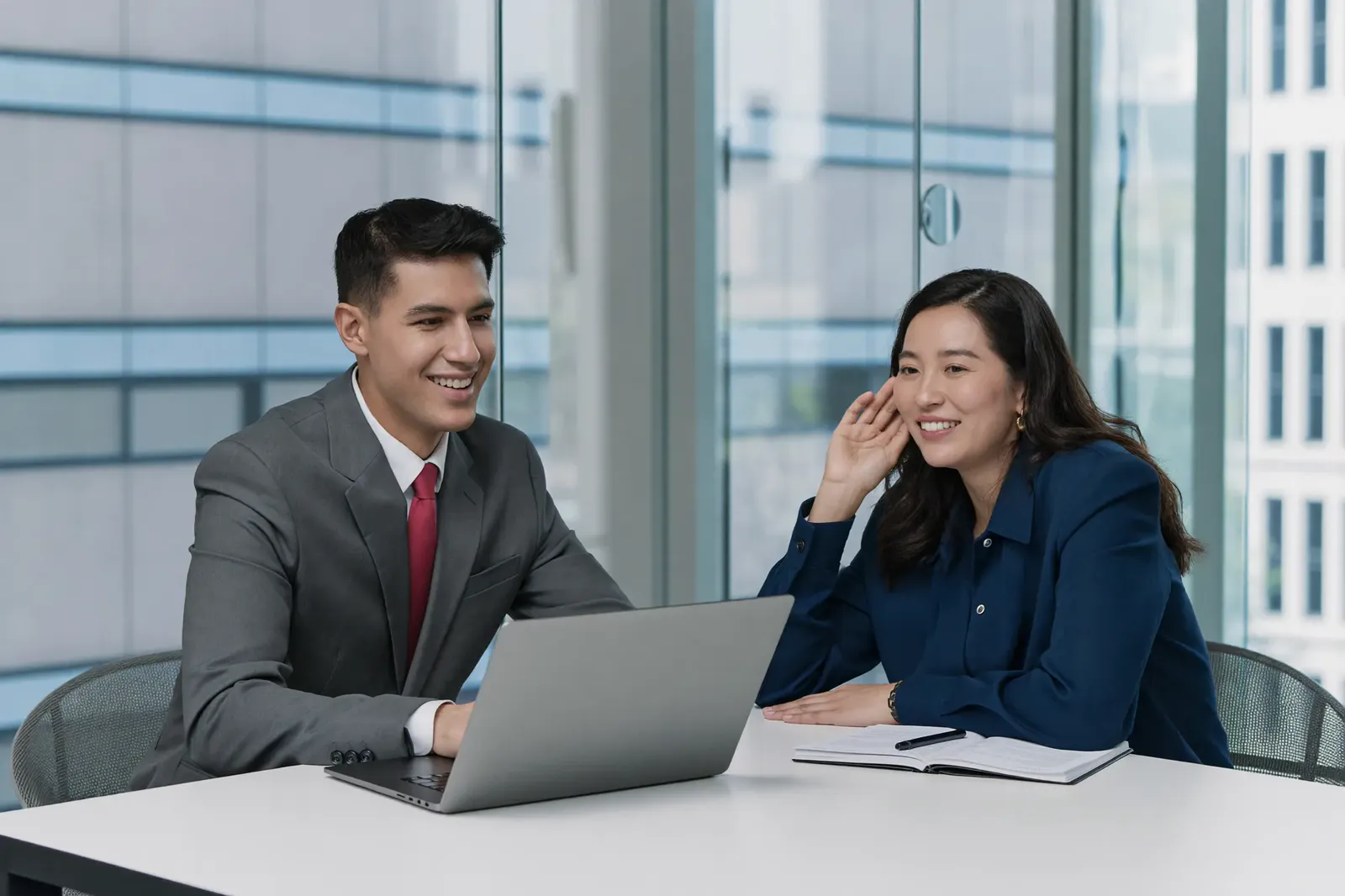 A coach and client looking at a booking calendar on a tablet